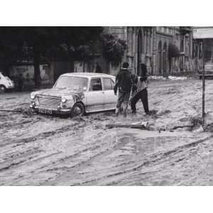 Automobiles Still Stuck in the Mud after the Flood in Florence Premium 