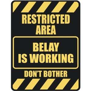   RESTRICTED AREA BELAY IS WORKING  PARKING SIGN