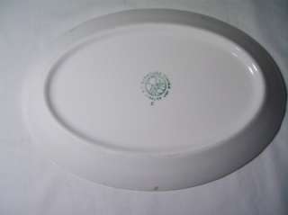 This is a Syracuse China   5 H Syralite oval plate. It features 
