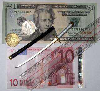 Currency and ruler shown to indicate size only. Currency and ruler 