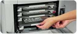 The printer provides front access to toner cartridges and paper trays 