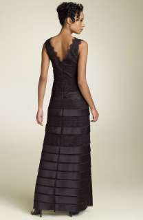 Lace and satin stripes on black mesh overlay a floor length gown 