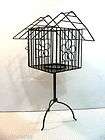 gray finished wrought iron cage pillar candle holder with a