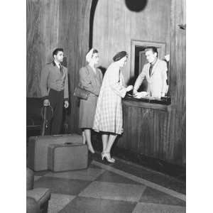 Two Women and Doorman Standing at Reception Desk in Hotel 