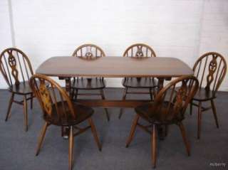 EXTENDING ERCOL DARK WOOD TABLE & 6 FLUER DE LYES  